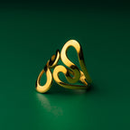 Coastal wave gold ring with a Celtic design on a green background