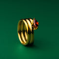 Isabella solitaire stack gold ring with a red gemstone on a green background