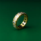 Luna eternity gold ring with embedded gemstones on a green background