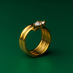 Solitaire stack gold ring with a gem on a green background